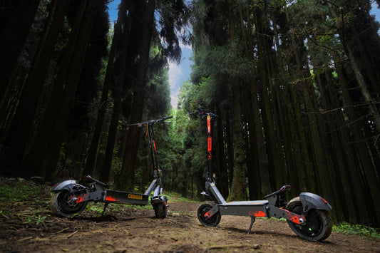 KuKirin electric scooters parked on a forest path