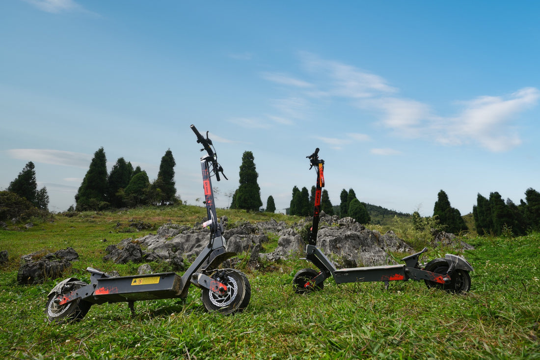 Two KuKirin electric scooters on a grassy outdoor trail