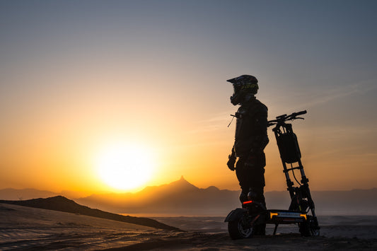 KuKirin electric scooter rider preparing for a longer ride at sunset